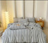 Cotton Quilt Cover Set in stylish gray and white stripes on a cozy bed with decorative pillows and modern bedding features.