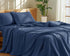 100 Percent Washed Cotton Sheet Set in navy blue color on a neatly made bed, showcasing luxury and comfort.